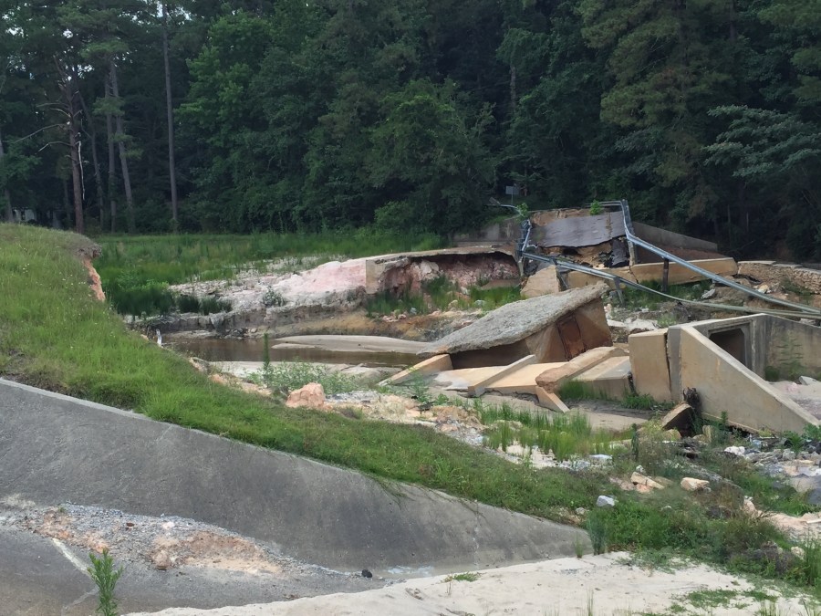 This dam in Columbia has not been repaired yet, preventing the road over it from being repaired._246844