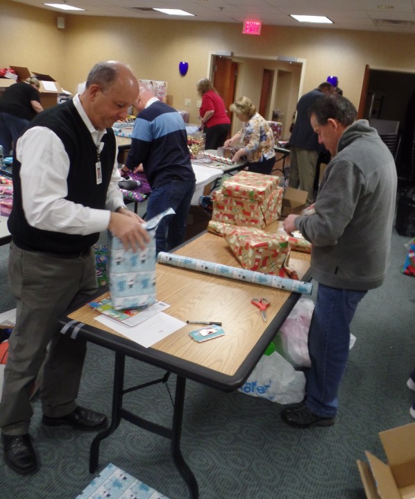 Greg Caples and Dr. Andrew Schwartz wrapping gifts_323671