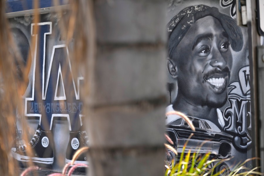 A portion of a mural by artist sloe_motions depicting Tupac Shakur is seen on the side of Speedy Auto Tint on Friday, Sept. 29, 2023, in Bellflower, Calif. (AP Photo/Chris Pizzello)