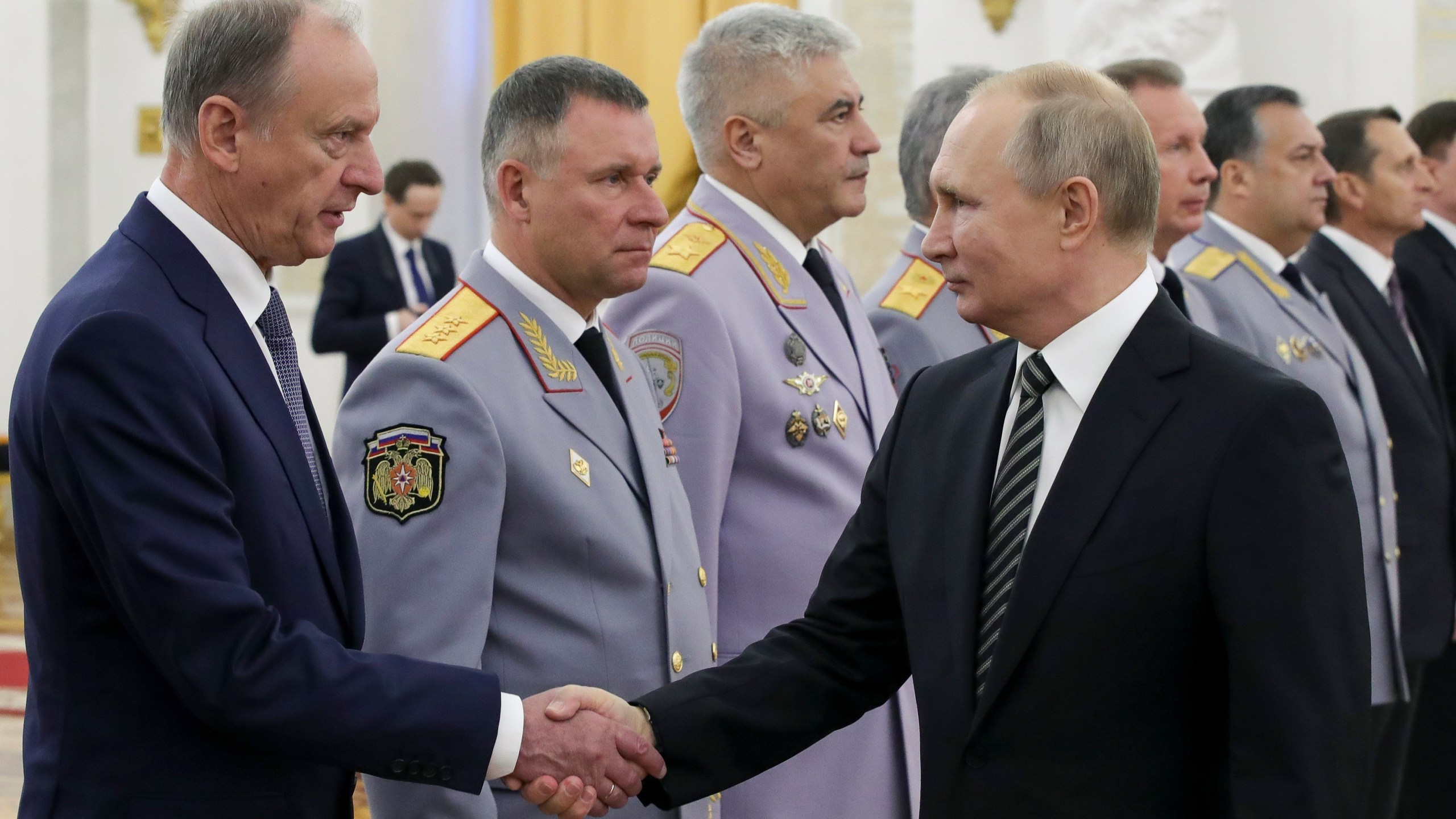 FILE - Russian President Vladimir Putin shakes hands with Russian Security Council chairman Nikolai Patrushev, left, as he greets senior military officers during a meeting in Moscow, Russia, Wednesday, Nov. 6, 2019. Patrushev could be an establishment-supported candidate for Russian president if Vladimir Putin does not run for reelection or becomes incapacitated before the vote in March 2024. (Mikhail Klimentyev, Sputnik, Kremlin Pool Photo via AP, File)