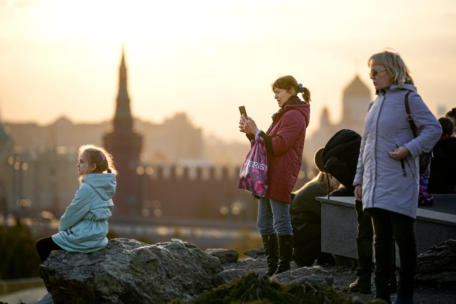 People enjoy a warm autumn sunset at Zaryadye Park near Red Square with the Kremlin in the background in Moscow, Russia, on Wednesday, Nov. 1, 2023. The temperature in Moscow rose to 14 degrees Celsius (57,2 Fahrenheit) and broke the 1934 record by 1.5 degrees Celsius, which is unusual for the beginning of November. (AP Photo/Alexander Zemlianichenko)