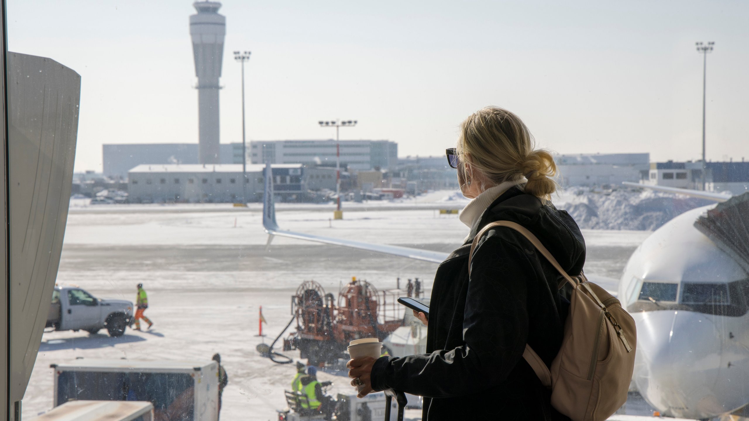 Airplanes and traffic control tower on tarmac below