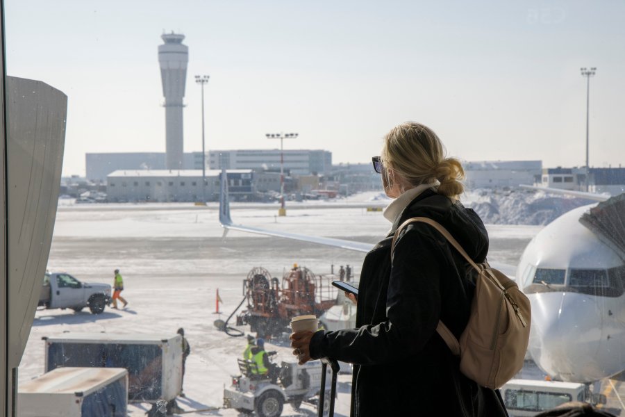 Airplanes and traffic control tower on tarmac below